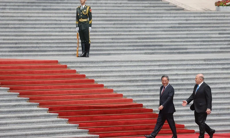 TOPSHOT - Russian Prime Minister Mikhail Mishustin (R) and Chinese Premier Li Qiang attend a welcoming ceremony in Beijing on May 24, 2023. (Photo by THOMAS PETER / POOL / AFP) (Photo by THOMAS PETER/POOL/AFP via Getty Images)