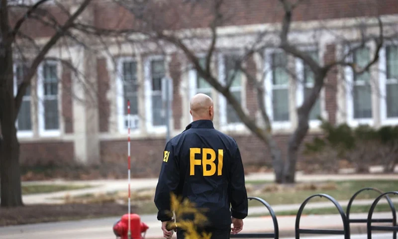 EAST LANSING, MICHIGAN - FEBRUARY 16: An FBI agent stands outside of Berkey Hall on the campus of Michigan State University on February 16, 2023 in East Lansing, Michigan. FBI agents were there to assist students and university staff in retrieving items which were left behind on February 13, when the building was evacuated after a gunman opened fire there and at another building on campus. Three students were killed and five others critically wounded. The gunman shot and killed himself a short time later during a confrontation with law enforcement officials. (Photo by Scott Olson/Getty Images)