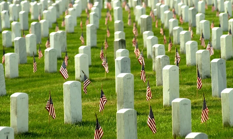 405877 03: American flags adorn each grave in Arlington National Cemetary in honor of Memorial Day May 27, 2002 in Arlington, VA. Thousands of tourists, veterans, armed services personnel, and relatives visited the cemetery in recognition of Memorial Day. (Photo by Stefan Zaklin/ Getty Images)