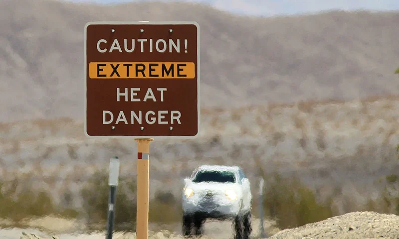 DEATH VALLEY NATIONAL PARK, CA JULY 14: Heat waves rise near a heat danger warning sign on the eve of the AdventurCORPS Badwater 135 ultra-marathon race on July 14, 2013 in Death Valley National Park, California. Billed as the toughest footrace in the world, the 36th annual Badwater 135 starts at Badwater Basin in Death Valley, 280 feet below sea level, where athletes begin a 135-mile non-stop run over three mountain ranges in extreme mid-summer desert heat to finish at 8,350-foot near Mount Whitney for a total cumulative vertical ascent of 13,000 feet. July 10 marked the 100-year anniversary of the all-time hottest world record temperature of 134 degrees, set in Death Valley where the average high in July is 116. A total of 96 competitors from 22 nations are attempting the run which equals about five back-to-back marathons. Previous winners have completed all 135 miles in slightly less than 24 hours. (Photo by David McNew/Getty Images)