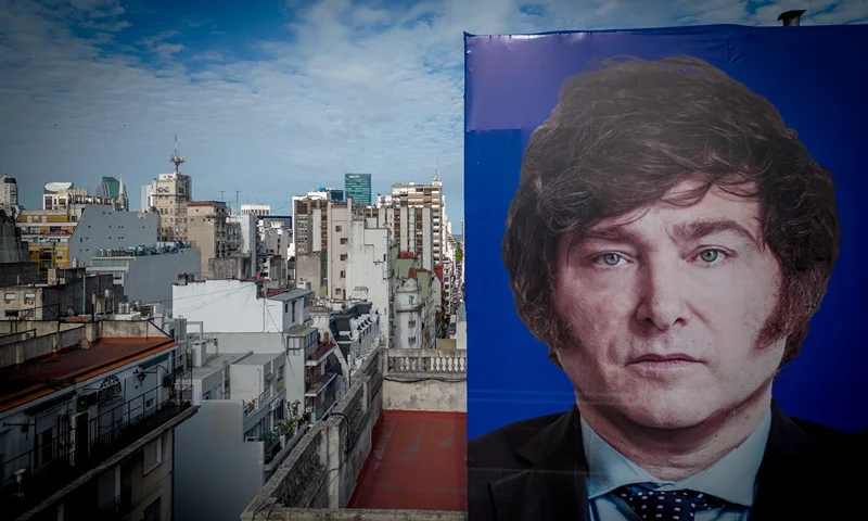 Argentinians Await Change of Government Amid Economic and Social Turmoil BUENOS AIRES, ARGENTINA - NOVEMBER 30: A Javier Milei picture is seen on a campaign sign on November 30, 2023 in Buenos Aires, Argentina. President-elect Javier Milei of La Libertad Avanza will take office on Sunday 10, replacing incumbent peronist Alberto Fernandez. Milei is a self-described "anarcho-capitalist" libertarian who wants to sharply reduce the size of the State and replace the local peso with the American dollar. During the campaign, he promised to uproot Argentina's political establishment and to align the economy with dramatic measures such as closing the Central Bank. After defeating the current Minister of Economy Sergio Massa in the run-off with 55,65% of the votes, the president-elect has shown moderation and pragmatism as he works on the line up of his cabinet. The new administration will face the challenge to reduce the country's 140% annual inflation and its 44,7% of poverty, as recently announced by a study carried out by ODSA-UCA. (Photo by Tomas Cuesta/Getty Images)