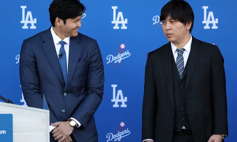 Los Angeles Dodgers Introduce Shohei Ohtani LOS ANGELES, CALIFORNIA - DECEMBER 14: Shohei Ohtani speaks with his interpreter Ippei Mizuhara prior to being introduced by the Los Angeles Dodgers at Dodger Stadium on December 14, 2023 in Los Angeles, California. (Photo by Meg Oliphant/Getty Images)