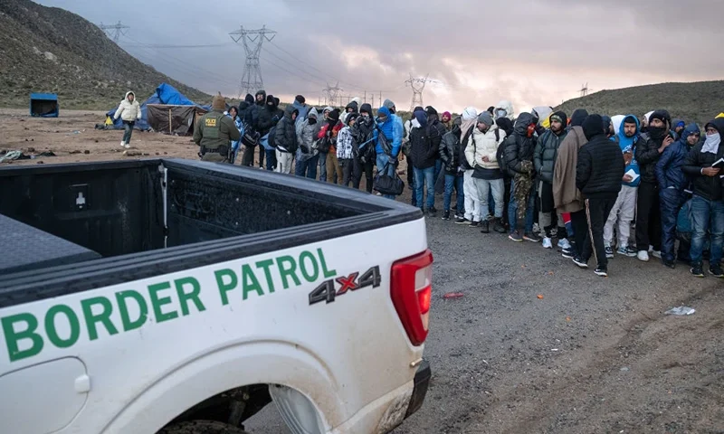 Asylum seekers wait in line to be processed by the Border Patrol at a makeshift camp near the US-Mexico border east of Jacumba, San Diego County, California, January 2, 2024. (Photo by Guillermo Arias / AFP) (Photo by GUILLERMO ARIAS/AFP via Getty Images)