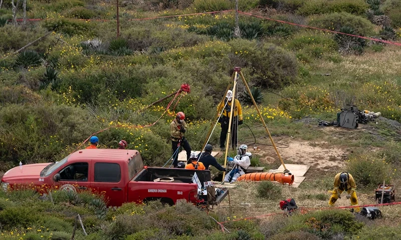 MEXICO-US-AUSTRALIA-MISSING-SURFERS A rescue worker descends into a waterhole where human remains were found near La Bocana Beach, Santo Tomas delegation, in Ensenada, Baja California State, Mexico, on May 3, 2024. . The FBI said on Friday that three bodies were found in Mexico's Baja California, near an area where two Australians and an American went missing last week during a surfing trip. "We confirm there were three individuals found deceased in Santo Tomas, Baja California," a statement from the FBI's office in San Diego said without providing identities of the victims. (Photo by Guillermo Arias / AFP) (Photo by GUILLERMO ARIAS/AFP via Getty Images)