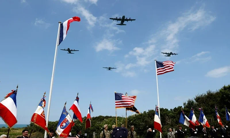 Lockheed C-130 Hercules aircraft overfly a ceremony on "Pointe du Hoc" clifftop in Cricqueville-en-Bessin, northwestern France, on June 5, 2024, as part of the "D-Day" commemorations marking the 80th anniversary of the World War II Allied landings in Normandy. The Pointe du Hoc was one of the strongholds in the German fortifications and was taken by force in a daring vertical assault by US Army Rangers on the morning of June 6, 1944 during the Normandy beach landings. The D-Day ceremonies on June 6 this year mark the 80th anniversary since the launch of 'Operation Overlord', a vast military operation by Allied forces in Normandy, which turned the tide of World War II, eventually leading to the liberation of occupied France and the end of the war against Nazi Germany. (Photo by Ludovic MARIN / AFP) (Photo by LUDOVIC MARIN/AFP via Getty Images)