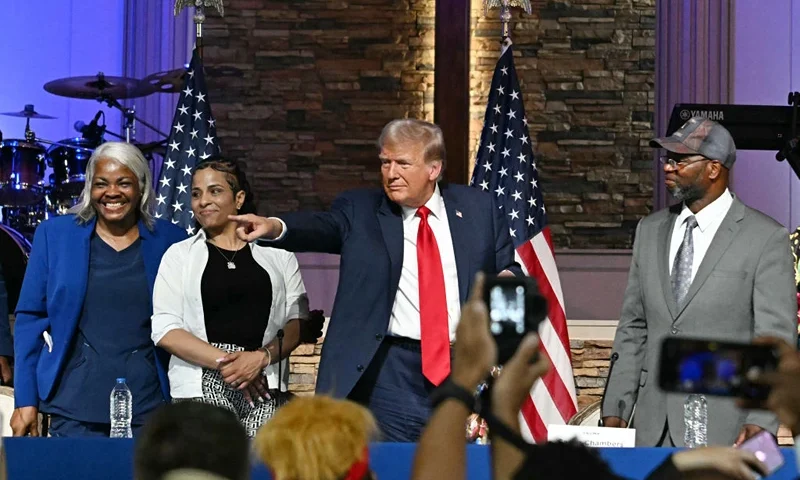 Former US President and Republican presidential candidate Donald Trump (C) participates in a community roundtable at the 180 Church in Detroit, Michigan, on June 15, 2024. (Photo by Jim WATSON / AFP) (Photo by JIM WATSON/AFP via Getty Images)