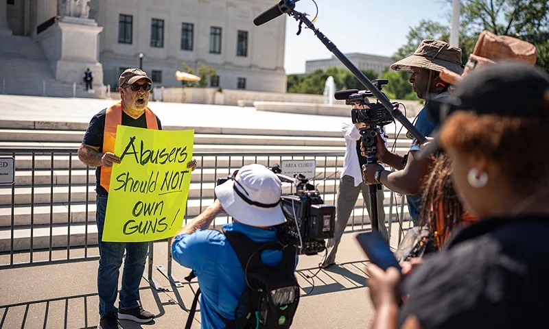 WASHINGTON, DC - JUNE 21: Christian Defense Coalition Director Rev. Patrick Mahoney speaks to members of the media as he holds a sign that reads "Abusers Should NOT Own Guns!" outside the Supreme Court on June 21, 2024 in Washington, DC. The Supreme Court issued five rulings today including the upholding of a law banning domestic abusers from owning guns but has not yet announced rulings on a variety of high profile cases including cases involving abortion rights, and former President Donald Trump's immunity claim. (Photo by Andrew Harnik/Getty Images)