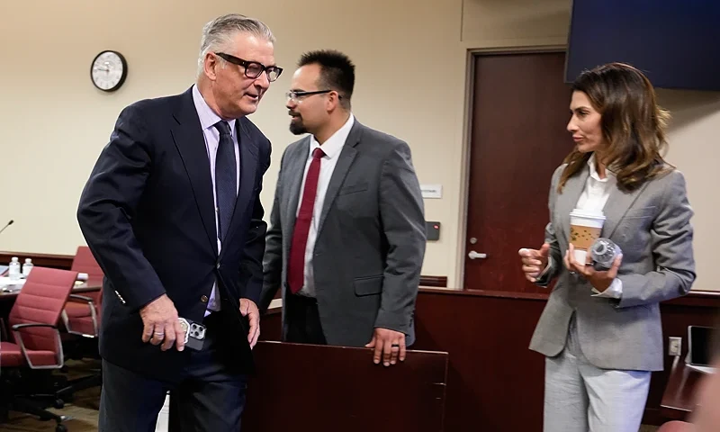 SANTA FE, NEW MEXICO - JULY 12: Actor Alec Baldwin (C) and his wife Hilaria Baldwin (R) depart the courtroom for a lunch break during his trial for involuntary manslaughter in First Judicial District Court on July 12, 2024 in Santa Fe, New Mexico. Baldwin is charged in the shooting death of cinematographer Halyna Hutchins on the set of the film "Rust" in 2021. (Photo by Ramsay de Give-Pool/Getty Images)