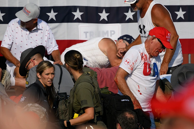 Donald Trump Holds A Campaign Rally In Butler, Pennsylvania
BUTLER, PENNSYLVANIA - JULY 13: Attendees scatter after gunfire rang out during a campaign rally for Republican presidential candidate, former U.S. President Donald Trump at Butler Farm Show Inc. on July 13, 2024 in Butler, Pennsylvania. Trump slumped before being whisked away by Secret Service with injuries visible to the side of his head. Butler County district attorney Richard Goldinger said the shooter and one audience member are dead and another was injured. (Photo by Jeff Swensen/Getty Images)