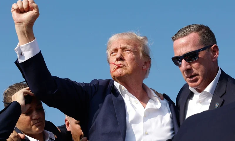 BUTLER, PENNSYLVANIA - JULY 13: Republican presidential candidate former President Donald Trump pumps his fist as he is rushed offstage during a rally on July 13, 2024 in Butler, Pennsylvania. Butler County district attorney Richard Goldinger said the shooter is dead after injuring former U.S. President Donald Trump, killing one audience member and injuring another in the shooting. (Photo by Anna Moneymaker/Getty Images)