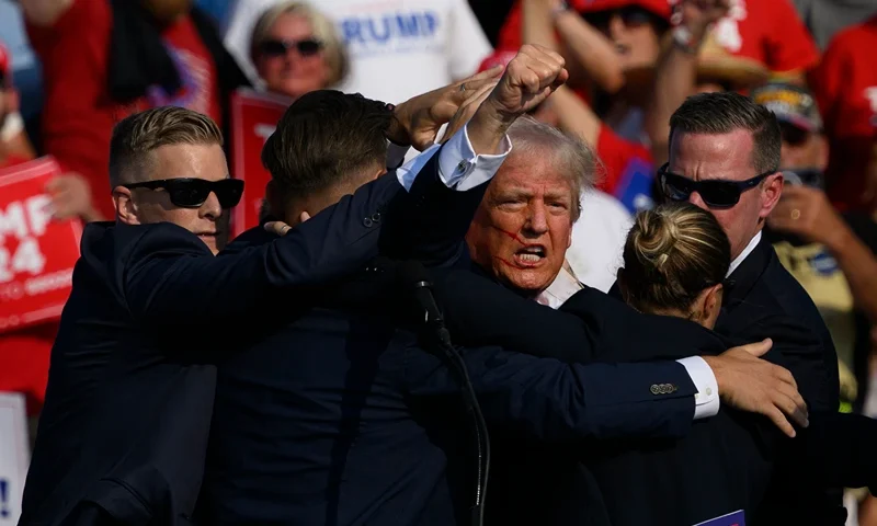 Donald Trump Holds A Campaign Rally In Butler, Pennsylvania BUTLER, PENNSYLVANIA - JULY 13: Secret Service agents surround Republican presidential candidate former President Donald Trump onstage after he was injured at a rally on July 13, 2024 in Butler, Pennsylvania. According to Butler County District Attorney Richard Goldinger, the suspected gunman is dead after injuring former President Trump, killing one audience member and injuring at least one other. (Photo by Jeff Swensen/Getty Images)