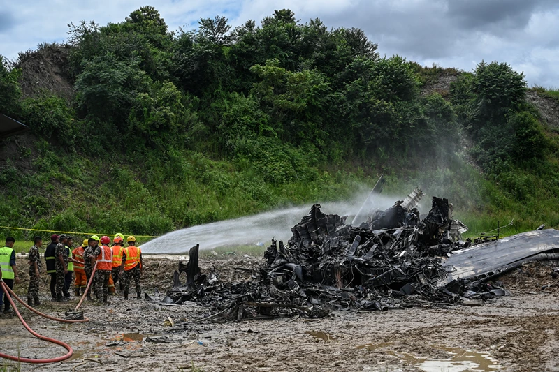 NEPAL-AVIATION-ACCIDENT
Firefighters try to douse a fire that erupted in a Saurya Airlines' plane after it crashed during takeoff at the Tribhuvan International Airport in Kathmandu on July 24, 2024. A passenger plane crashed on takeoff in Kathmandu on July 24, with the pilot rescued from the flaming wreckage but all 18 others aboard killed, police in the Nepali capital told AFP. (Photo by PRAKASH MATHEMA / AFP) (Photo by PRAKASH MATHEMA/AFP via Getty Images)