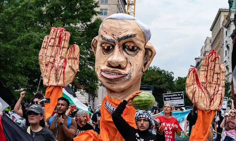 Pro-Palestinian demonstrators with an effigy of Israeli Prime Minister Benjamin Netanyahu protest near the White House to denounce US President Joe Biden meeting with Netanyahu in Washington, DC, on July 25, 2024. (Photo by andrew thomas / AFP) (Photo by ANDREW THOMAS/AFP via Getty Images)