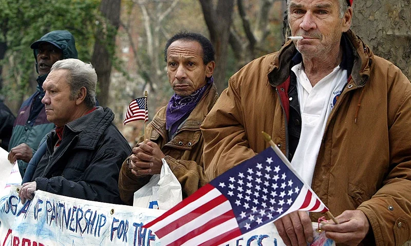 NEW YORK - NOVEMBER 11: Homeless veterans Matt Flanagan (R) and Eduardo Gonzalez (C) and Hector Lopez, who lost a brother in the Vietnam War, attend a Veterans Day Wreath Ceremony November 11, 2003 in New York City. Approximately one-third of all homeless men in New york City are U.S. veterans and nationwide nearly a half-million veterans are homeless during the course of a year. (Photo by Mario Tama/Getty Images)