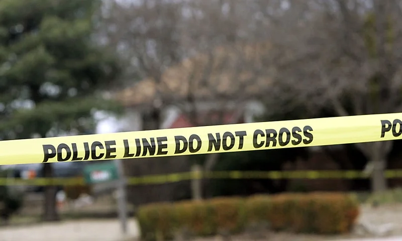 PARK CITY, KS - FEBRUARY 26: Police tape hangs across the street in front of the house that Dennis Rader lives in February 26, 2005 in Park City, Kansas. Rader is the suspect whom police have arrested on suspicion of first-degree murder in connection with the 10 deaths now tied to the serial killer known as BTK. (Photo by Larry W. Smith/Getty Images)