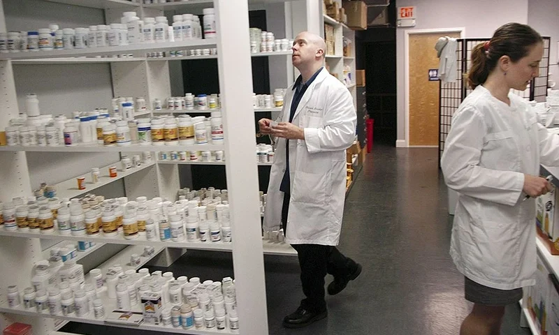 GLENSIDE, PA - SEPTEMBER 7: Pharmacist Howard Brooker(C) and his wife Pam Harvey (R) fill a prescription at Adams Discount Pharmacy September 7, 2006 in Glenside, Pennsylvania. Adams offers generic drugs for forty to seventy five percent cheaper than the brand name manufacturer's cost. They are able to charge low prices by not dealing with insurance companies. (Photo by William Thomas Cain/Getty Images)