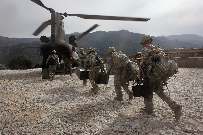 KORENGAL VALLEY, AFGHANISTAN - OCTOBER 27: U.S. soldiers board an Army Chinook transport helicopter after it brought fresh soldiers and supplies to the Korengal Outpost on October 27, 2008 in the Korengal Valley, Afghanistan. The military spends huge effort and money to fly in supplies to soldiers of the 1-26 Infantry based in the Korengal Valley, site of some of the fiercest fighting of the Afghan war. The unpaved road into the remote area is bad and will become more treacherous with the onset of winter. (Photo by John Moore/Getty Images)