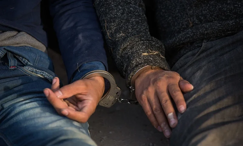 TOPSHOT - After being apprehended by Border Patrol, illegal immigrants wait to be transported to a central processing center shortly after they crossed the border from Mexico into the United States on Monday, March 26, 2018 in the Rio Grande Valley Sector near McAllen, Texas. An estimated 11 million undocumented immigrants live in the United States, many of them Mexicans or from other Latin American countries. (Photo by Loren ELLIOTT / AFP) (Photo by LOREN ELLIOTT/AFP via Getty Images)