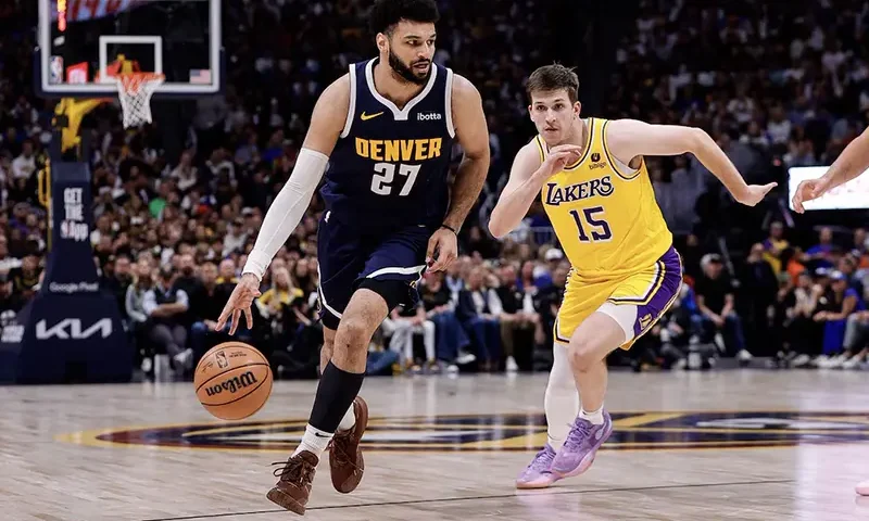 Denver Nuggets guard Jamal Murray (27) controls the ball ahead of Los Angeles Lakers guard Austin Reaves (15) in the third quarter during game five of the first round for the 2024 NBA playoffs at Ball Arena. Mandatory Credit: Isaiah J. Downing-USA TODAY Sports