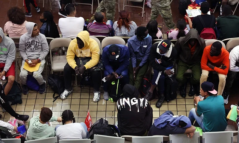 NEW YORK, NEW YORK - MAY 15: Newly arrived asylum seekers wait in a holding area at the Port Authority bus terminal before being sent off to area shelters and hotels on May 15, 2023 in New York City. The historic Roosevelt Hotel in midtown is being prepped to reopen shortly to accommodate an anticipated influx of asylum seekers into New York City. With migrants arriving weekly on buses from Texas and other parts of the country, Mayor Eric Adams' administration is under pressure to find shelter for the thousands of individuals and families looking to start new lives in America. Mayor Adams announced Saturday that the city will utilize the closed hotel to eventually provide as many as 1,000 rooms for migrants. (Photo by Spencer Platt/Getty Images)