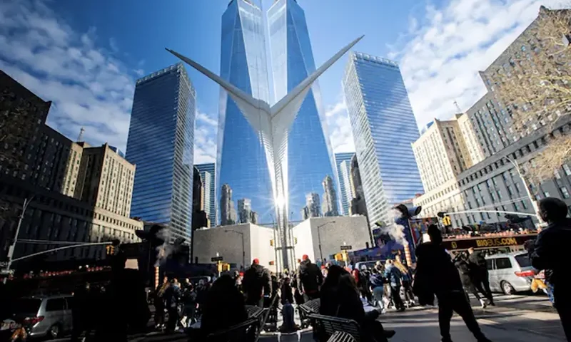 People walk around the Financial District near the New York Stock Exchange (NYSE) in New York, U.S., December 29, 2023. REUTERS/Eduardo Munoz/File Photo