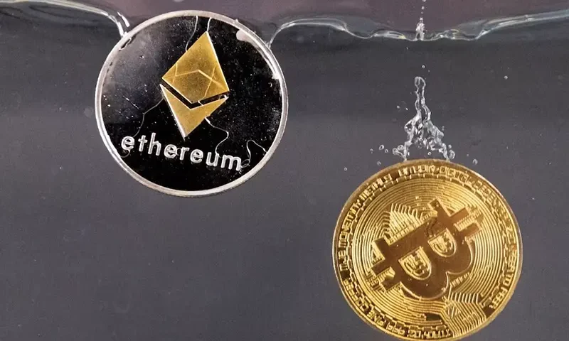 Souvenir tokens representing cryptocurrency Bitcoin and the Ethereum network, with its native token ether, plunge into water in this illustration taken May 17, 2022. REUTERS/Dado Ruvic/Illustration/File Photo