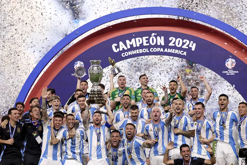 Argentina's Lionel Messi lifts the trophy as he celebrates with teammates after winning Copa America 2024 REUTERS/Agustin Marcarian