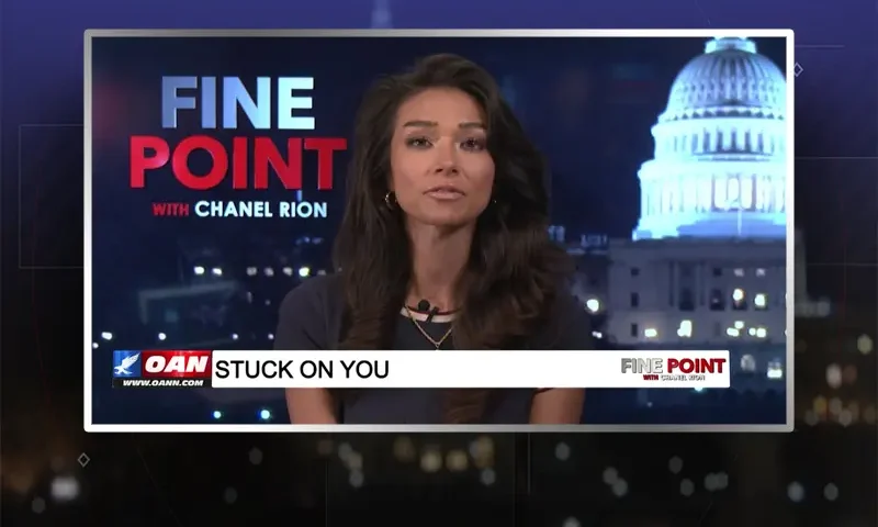 Video still of the host of Fine Point at the desk of their talk show on One America News Network.