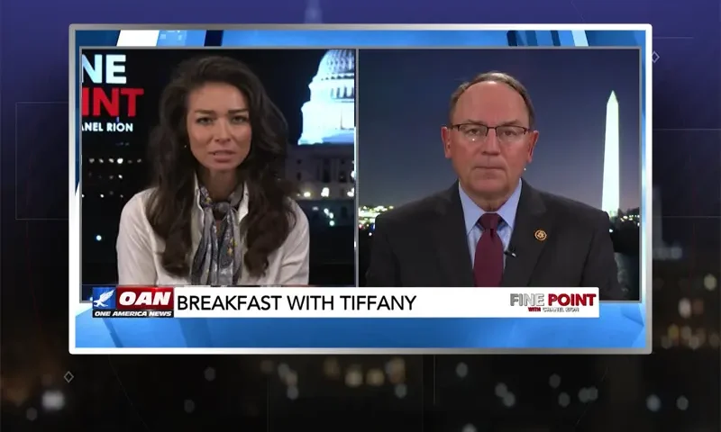 Video still from Fine Point on One America News Network showing a split screen of the host on the left side, and on the right side is the guest, Tom Tiffany.