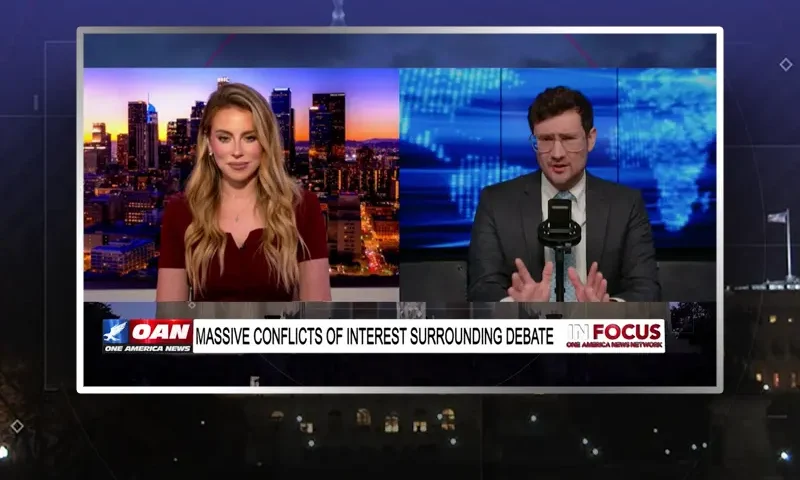 Video still from In Focus on One America News Network showing a split screen of the host on the left side, and on the right side is the guest, Harrison Smith.