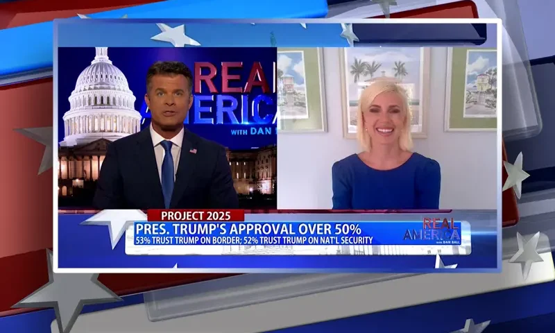 Video still from Real America on One America News Network showing a split screen of the host on the left side, and on the right side is the guest, Caroline Sunshine.