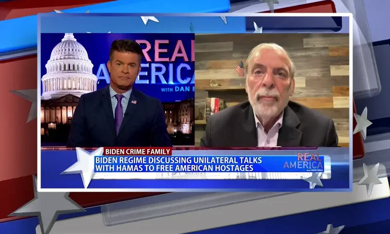 Video still from Real America on One America News Network showing a split screen of the host on the left side, and on the right side is the guest, Dov Hikind.