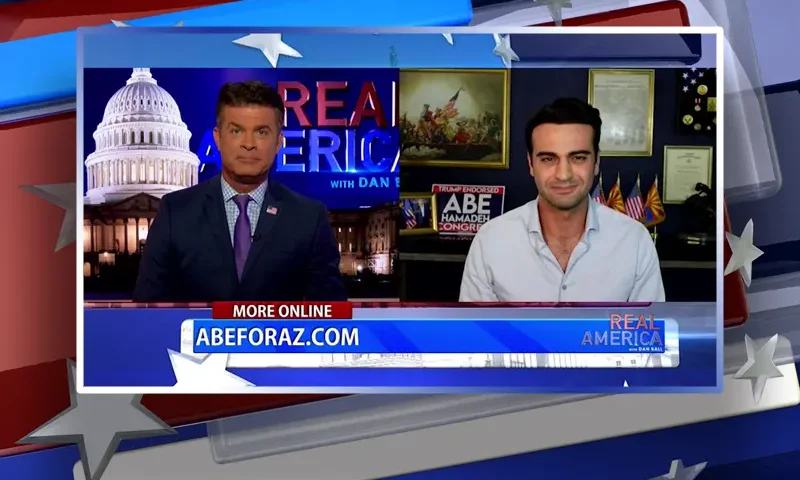 Video still from Real America on One America News Network showing a split screen of the host on the left side, and on the right side is the guest, Abe Hamadeh.