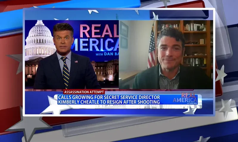 Video still from Real America on One America News Network showing a split screen of the host on the left side, and on the right side is the guest, Joe Kent.