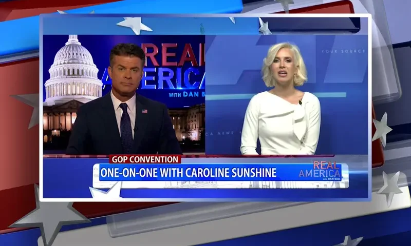 Video still from Real America on One America News Network showing a split screen of the host on the left side, and on the right side is the guest, Caroline Sunshine.