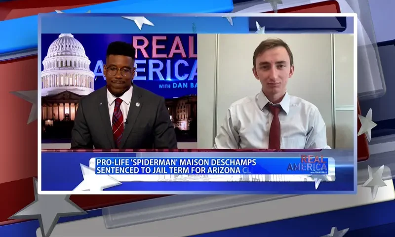 Video still from Real America on One America News Network showing a split screen of the host on the left side, and on the right side is the guest, Maison DesChamps.