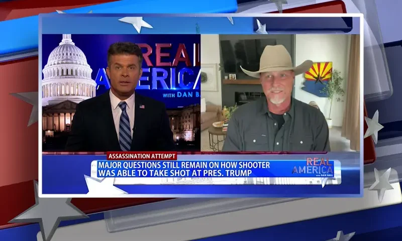 Video still from Real America on One America News Network showing a split screen of the host on the left side, and on the right side is the guest, Mark Lamb.