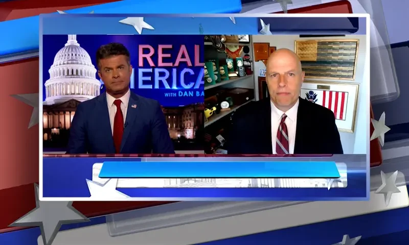 Video still from Real America on One America News Network showing a split screen of the host on the left side, and on the right side is the guest, Ron Vitiello.