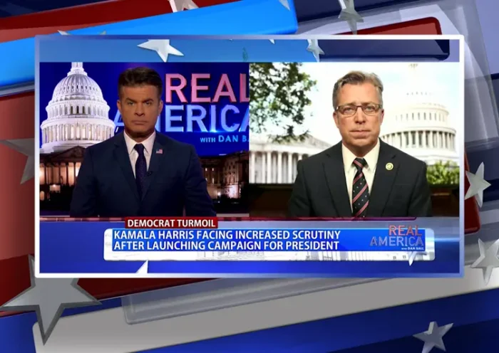 Video still from Real America on One America News Network showing a split screen of the host on the left side, and on the right side is the guest, Rep. Andy Ogles.