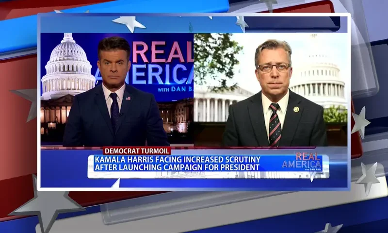 Video still from Real America on One America News Network showing a split screen of the host on the left side, and on the right side is the guest, Rep. Andy Ogles.