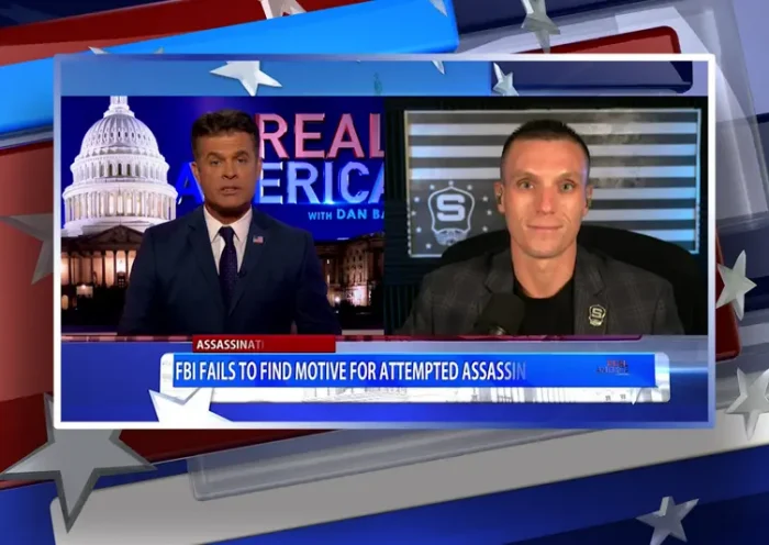 Video still from Real America on One America News Network showing a split screen of the host on the left side, and on the right side is the guest, Steve Friend.