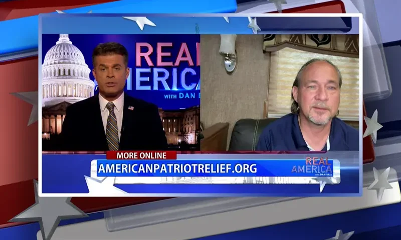 Video still from Real America on One America News Network showing a split screen of the host on the left side, and on the right side is the guest, Mark Middleton.