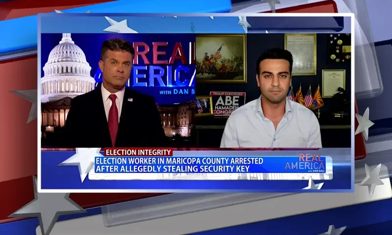 Video still from Real America on One America News Network showing a split screen of the host on the left side, and on the right side is the guest, Abe Hamadeh.