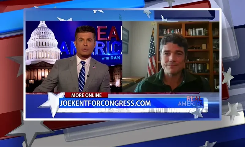 Video still from Real America on One America News Network showing a split screen of the host on the left side, and on the right side is the guest, Joe Kent.