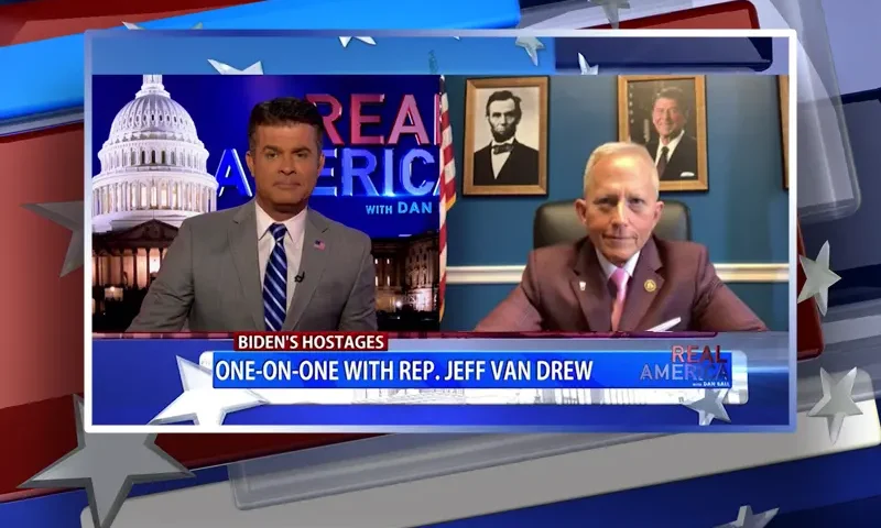 Video still from Real America on One America News Network showing a split screen of the host on the left side, and on the right side is the guest, Rep. Jeff Van Drew.