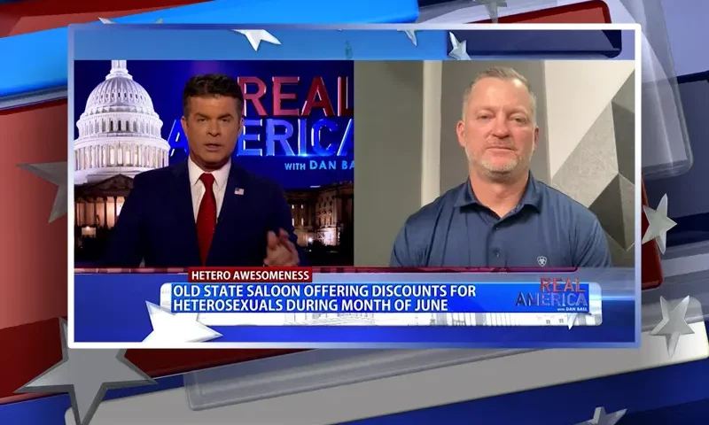 Video still from Real America on One America News Network showing a split screen of the host on the left side, and on the right side is the guest, Mark Fitzpatrick.