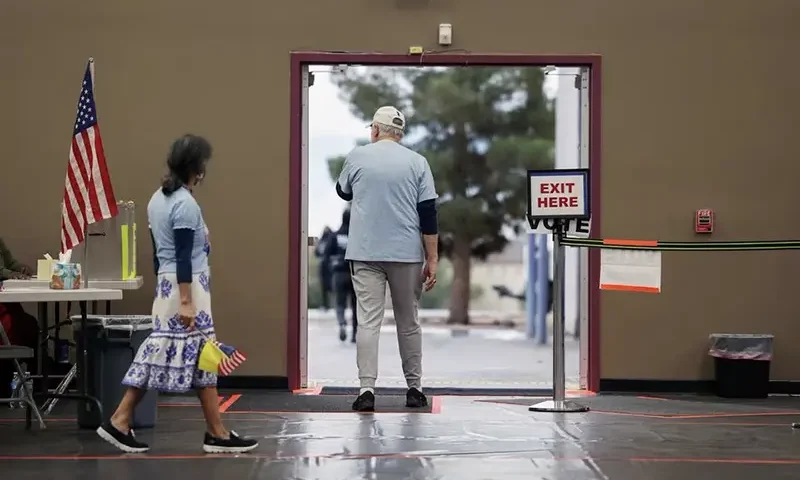 Volunteers watch for voters to arrive shortly after the polls open as Democrats and Republicans hold their presidential primary election in Las Vegas, Nevada, U.S., February 6, 2024. REUTERS/Ronda Churchill/File Photo